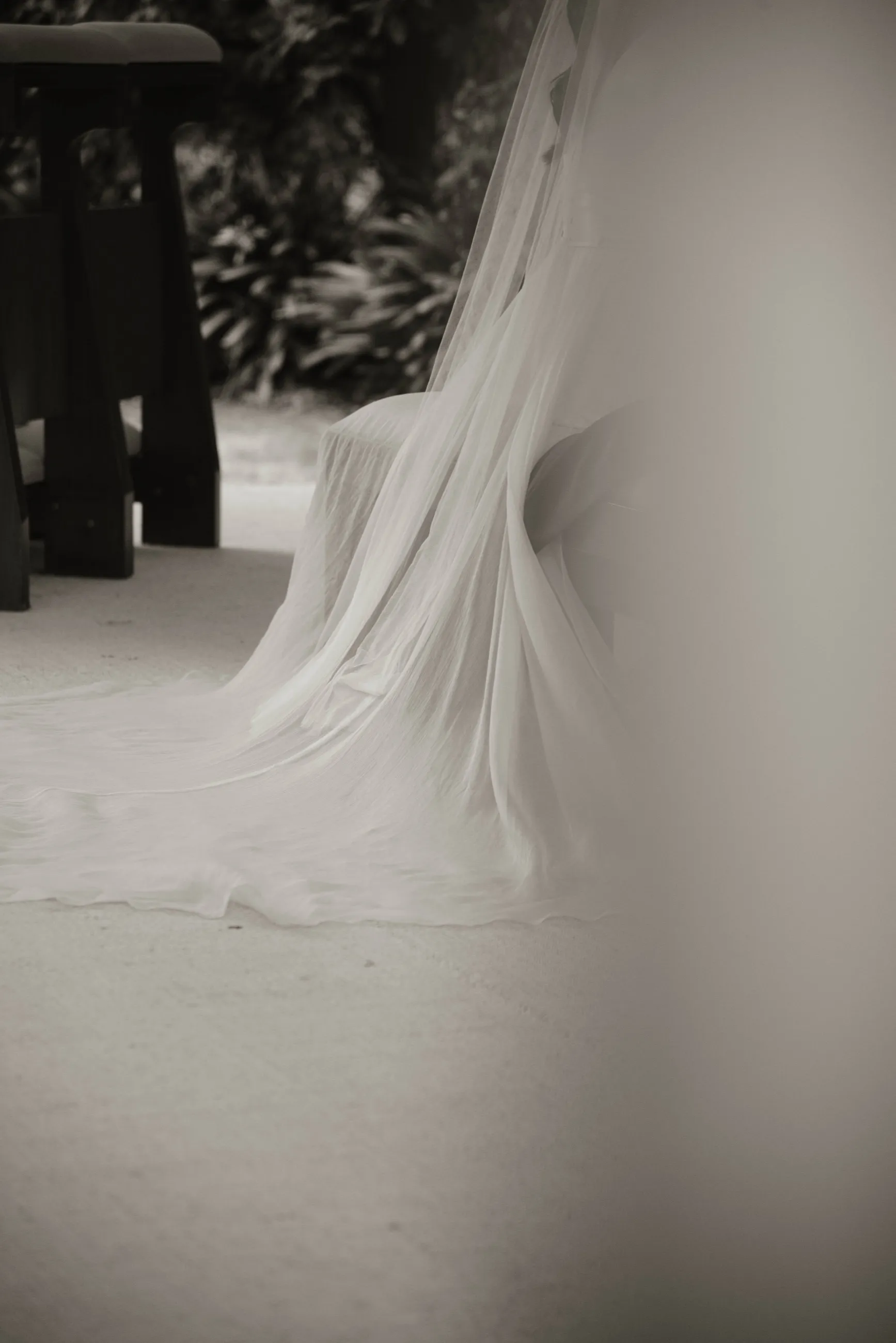 Cola del vestido de novia de tul extendida sobre el suelo, en blanco y negro